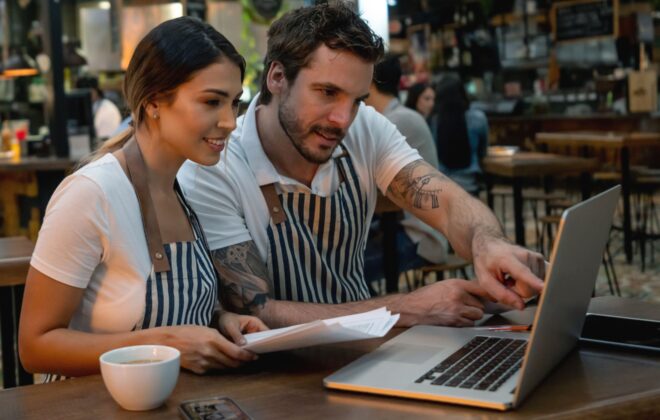 Due dipendenti di ristorante usano il software rilevazione presenze al laptop con Jobby